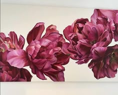 a painting of pink flowers on a white wall