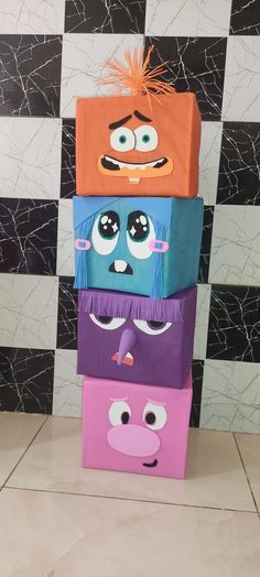 four colorful boxes with faces on them