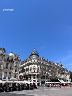 people are walking around in front of some buildings