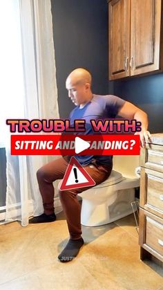 a man sitting on top of a toilet next to a sign that says trouble with sitting and standing