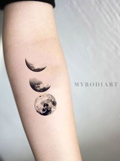 a woman's arm with three phases of the moon on it