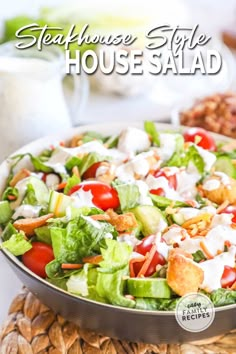 a close up of a salad in a pan on a table with the words stayhouse style house salad