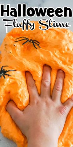 a child's hand reaching for an orange slime with black spider webs on it