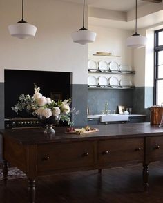 the kitchen is clean and ready to be used for cooking or baking, with flowers on the counter