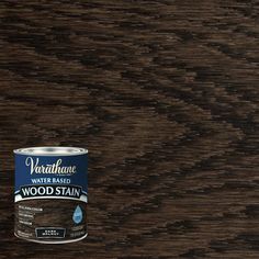 a can of wood stain sitting on top of a wooden table