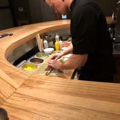 a man standing at a counter preparing food