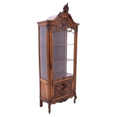 an ornate display cabinet with glass doors