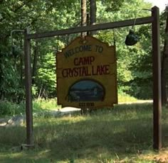 a welcome sign to camp crystal lake in the woods