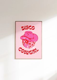 a pink poster hanging on the side of a wall