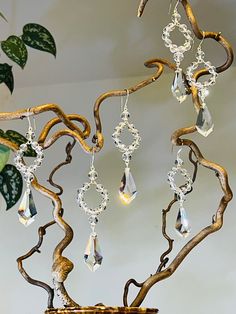 a metal tree with crystal beads hanging from it's branches