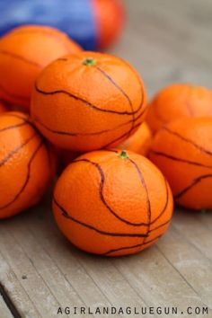 a pile of oranges sitting on top of a wooden table next to each other