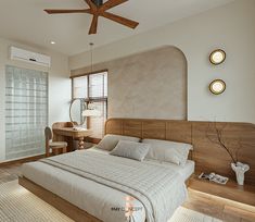 a large bed sitting under a wooden ceiling fan