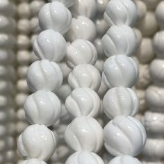 some white beads are stacked together on a table