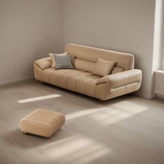 an empty living room with a couch and ottoman