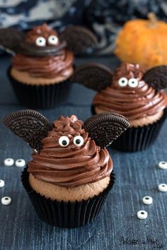 three cupcakes with chocolate frosting and decorated ears