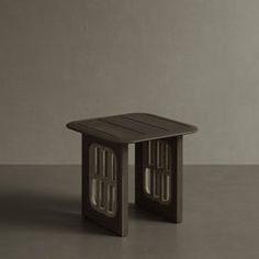 a small wooden table sitting on top of a gray floor