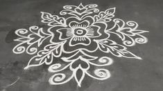 a white flower is drawn on the ground