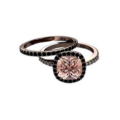 two engagement rings with black and white diamonds on each ring, one pink diamond in the center