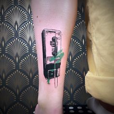 a person with a tattoo on their leg has a phone in the middle of it