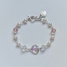 A sweet handmade bracelet ✿ Made with freshwater pearls, glass crystal beads, and metal accents ✿ Pearlescent white, iridescent clear, pink, and silver ✿ Toggle Clasp Wired Bracelets With Beads, White Beaded Bracelets, Bracelets Cute, Rose Milk, Bracelet Inspiration, Jewellery Bracelets, Cute Bracelet, Beading Jewelery, Pastel Outfit