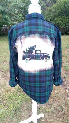 a plaid shirt with a truck and trees on it