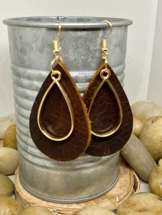 "Handmade, genuine leather charm teardrop earrings measuring Aprox 2\" long in a variety of colors and metal color options either tools or silver. Available options are: Weathered brown leather teardrop earrings with coordinating charm in silver or gold Camel, cognac teardrop earrings with coordinating charm in silver or gold Hunter green, Forrest green teardrop earrings with coordinating charm in silver or gold Teardrop earrings, gold earrings, silver earrings, fall earrings, camel earrings, co Everyday Nickel Free Dangle Earrings, Everyday Use Nickel-free Dangle Earrings, Handmade Brown Teardrop Dangle Earrings, Brown Brass Dangle Earrings, Leather Dangle Earrings With Ear Wire, Handmade Brown Faux Leather Earrings, Brown Brass Drop Earrings, Gold Leather Dangle Earrings, Brown Teardrop Single Earring