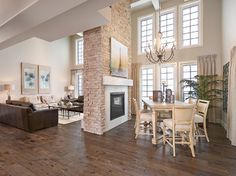 a living room filled with furniture and a fire place in the middle of a room