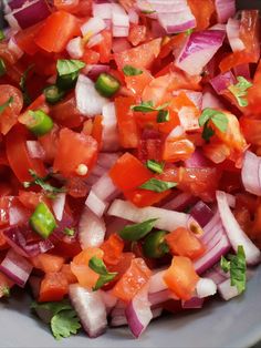 a white bowl filled with chopped vegetables on top of a table