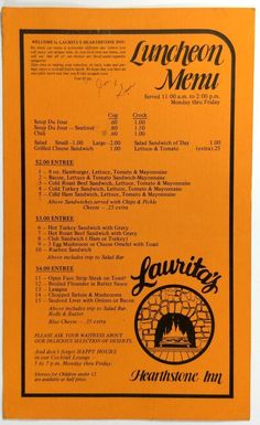 an orange menu with black writing on the front and back of it, featuring a brick fireplace