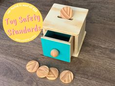 a toy safety stand with four wooden knobs on it and a sign that says,