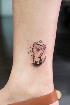 a small cat tattoo on the ankle