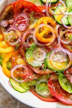 a white bowl filled with sliced up vegetables