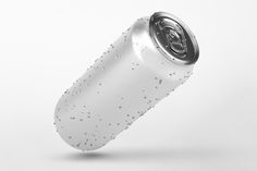 an empty soda can flying through the air with bubbles on it's body and bottom