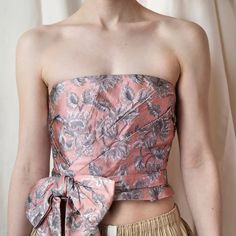 Pink and silver brocade top, seen on Prada’s SS 2018 runway and campaign. Super feminine and cute, the strapless top features an asymmetrical bow detail and small peplum at the waist for a flattering look. Zips at the back with an adjustable interior hook and eye at the waist for a true fit, pulling up your top all night is not a concern here. Incredibly versatile in styling options. Size: IT 36, US 2Composition: Synthetic blendCondition: Great, small snag at back waist, barely visible Chic Tube Top For Gala, Silk Bandeau Tube Top For Party, Strapless Feminine Tube Top For Party, Silk Strapless Tube Top, Elegant Pink Bandeau Tube Top, Elegant Pink Strapless Tube Top, Elegant Festive Brocade Tops, Fitted Brocade Top With Unique Design, Luxury Brocade Festive Tops