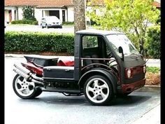 a small car is parked on the side of the road in front of a house