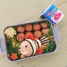 a plastic container filled with food on top of a wooden table