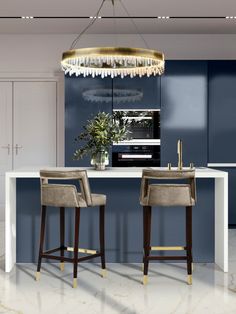 a kitchen with two bar stools and a chandelier