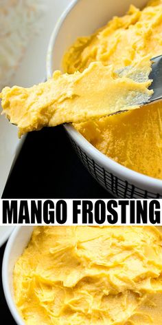 two white bowls filled with mango frosting on top of a black counter next to a metal spatula