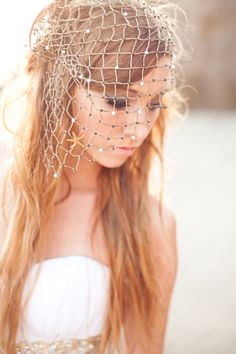 a woman with long hair wearing a veil