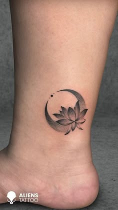 a lotus flower tattoo on the ankle is shown in black and grey ink, with a crescent