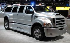 a large white truck parked on top of a cement floor