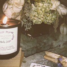 a candle and some flowers on a table