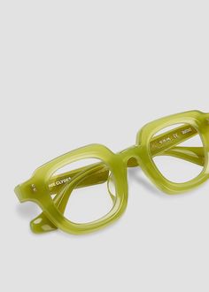 Rounded frames with an angular brow and curved nose bridge. Arm temples feature injected stainless steel core wire and flower metal detailing. Milky green frames with blue light filtering lenses. Rx lenses available. Modern Green Glass Sunglasses, Colorful Glasses Frames, Green Glasses Frames, Curved Nose, Glasses Frames Trendy, Glasses Inspiration, Funky Glasses, Unique Glasses, Womens Glasses Frames