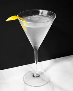 a martini glass with a lemon garnish on the rim