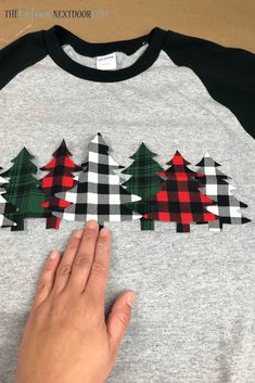 someone is cutting out christmas trees on a t - shirt to make it look like they are