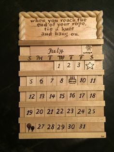 a wooden calendar with writing on it