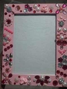 a pink frame with lots of buttons and pearls