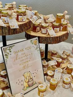 there are many honey jars on the table with thank you cards and tags in front of them