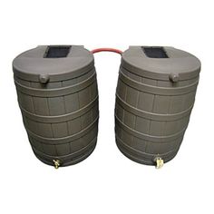 two large gray barrels sitting next to each other