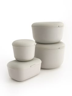 three white bowls stacked on top of each other in front of a white background,